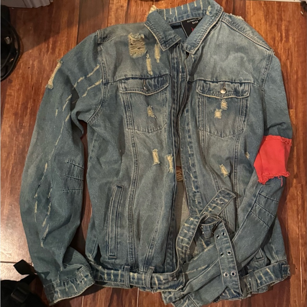 Distressed Denim Jacket with Red Patch